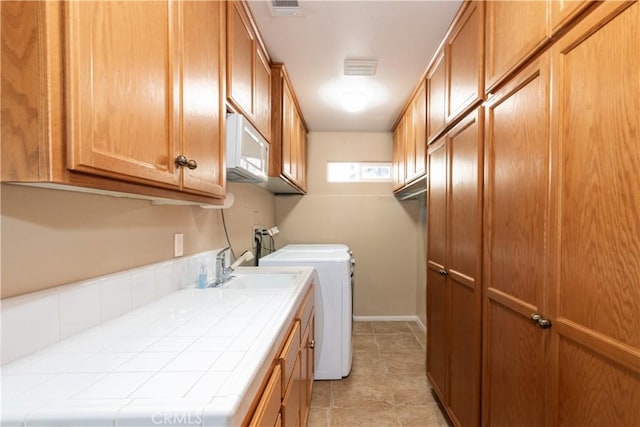 8674 Paseo De Vaca, Atascadero, CA 93422 - laundry room featuring cabinet space, washer and clothes dryer, and light tile patterned floors