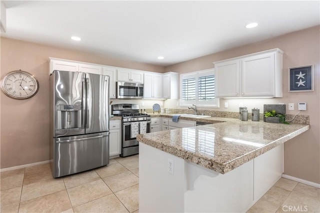 8674 Paseo De Vaca, Atascadero, CA 93422 - kitchen with appliances with stainless steel finishes, a peninsula, white cabinets, recessed lighting, and light tile patterned floors