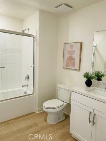 1810 E First St Unit 29, Santa Ana, CA 92705 - full bathroom featuring vanity, wood finished floors, and enclosed tub / shower combo