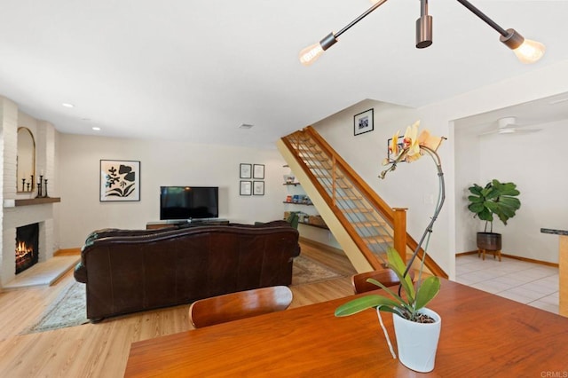 2005 Countrywood Ct, Encinitas, CA 92024 - living area with a brick fireplace, a ceiling fan, recessed lighting, stairway, and light wood-style flooring