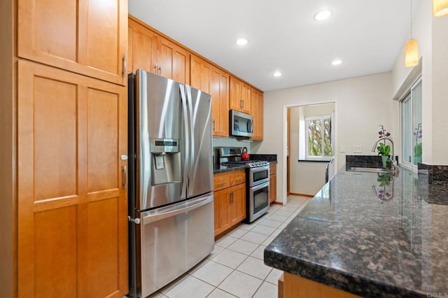 2005 Countrywood Ct, Encinitas, CA 92024 - kitchen with stainless steel appliances, light tile patterned flooring, recessed lighting, a peninsula, and dark stone countertops