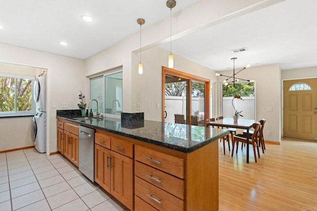 2005 Countrywood Ct, Encinitas, CA 92024 - kitchen featuring stainless steel dishwasher, stacked washer / dryer, plenty of natural light, brown cabinetry, and recessed lighting