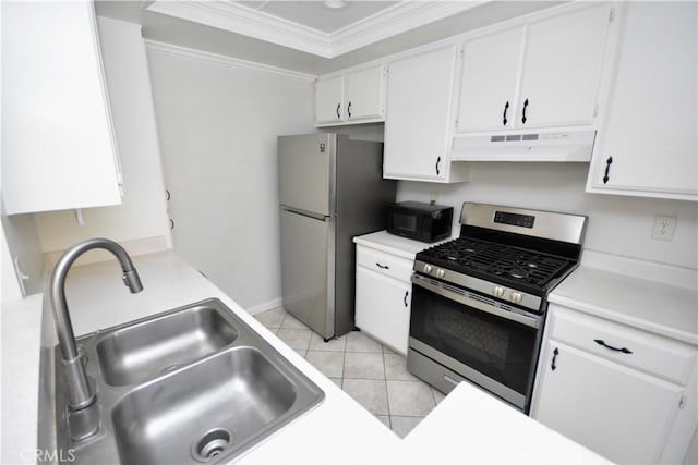 16377 Lakeshore Dr Unit 4D, Lake Elsinore, CA 92530 - kitchen featuring stainless steel gas stove, under cabinet range hood, freestanding refrigerator, ornamental molding, and black microwave