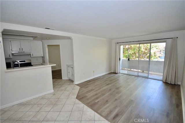16377 Lakeshore Dr Unit 4D, Lake Elsinore, CA 92530 - unfurnished living room featuring crown molding and light tile patterned floors