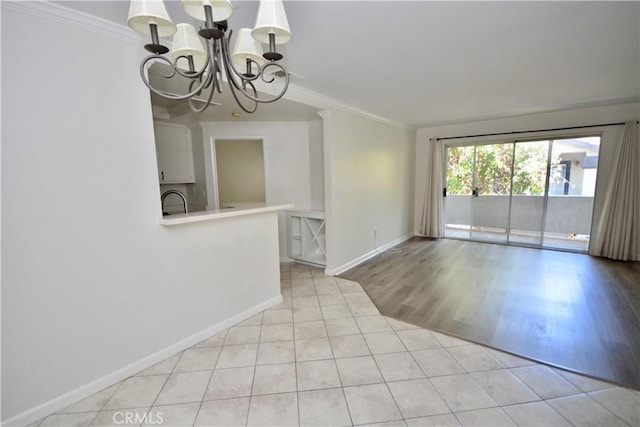 16377 Lakeshore Dr Unit 4D, Lake Elsinore, CA 92530 - spare room featuring ornamental molding, a chandelier, and light tile patterned floors