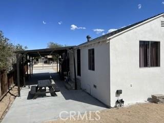 62026 Grand View Cir, Joshua Tree, CA 92252 - view of side of property with a patio and stucco siding
