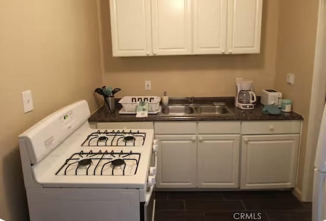 62026 Grand View Cir, Joshua Tree, CA 92252 - kitchen with white gas stove, white cabinets, and dark countertops