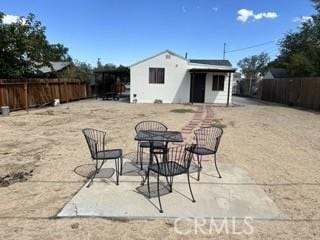 62026 Grand View Cir, Joshua Tree, CA 92252 - fenced backyard with an outdoor structure and a patio