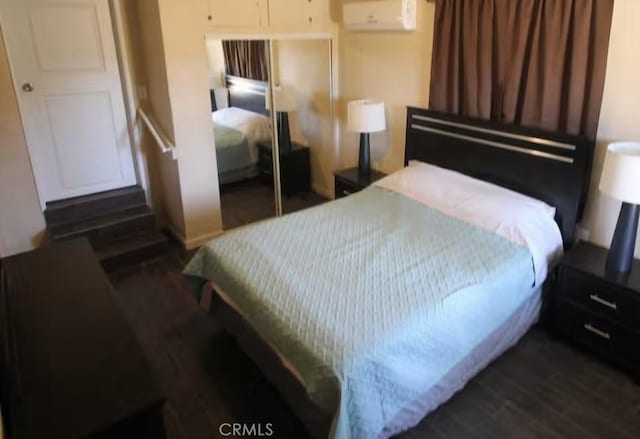 62026 Grand View Cir, Joshua Tree, CA 92252 - bedroom featuring a closet, a wall mounted air conditioner, and dark wood finished floors