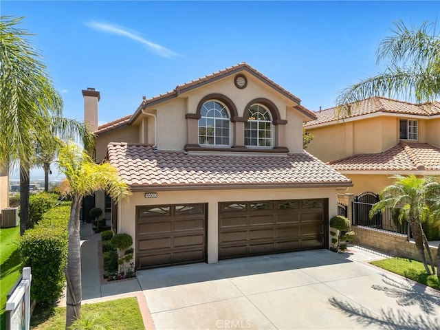 19900 Mariposa Creek Way, Porter Ranch, CA 91326 - mediterranean / spanish home with an attached garage, driveway, stucco siding, a tile roof, and a chimney