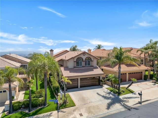 19900 Mariposa Creek Way, Porter Ranch, CA 91326 - mediterranean / spanish-style home featuring driveway, a tiled roof, stucco siding, a chimney, and a garage
