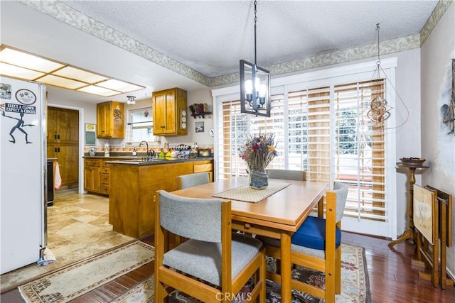 1595 15th St, Los Osos, CA 93402 - dining area with a textured ceiling, a chandelier, and light wood-type flooring