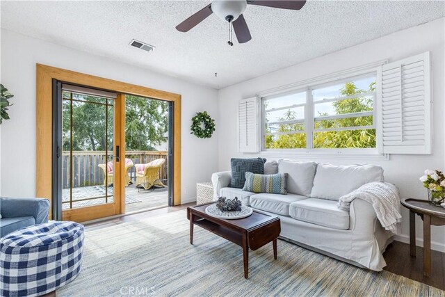 1595 15th St, Los Osos, CA 93402 - living area with healthy amount of natural light, wood finished floors, a textured ceiling, and ceiling fan