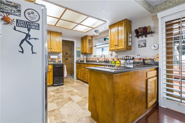 1595 15th St, Los Osos, CA 93402 - kitchen featuring freestanding refrigerator, a peninsula, brown cabinets, and dark countertops