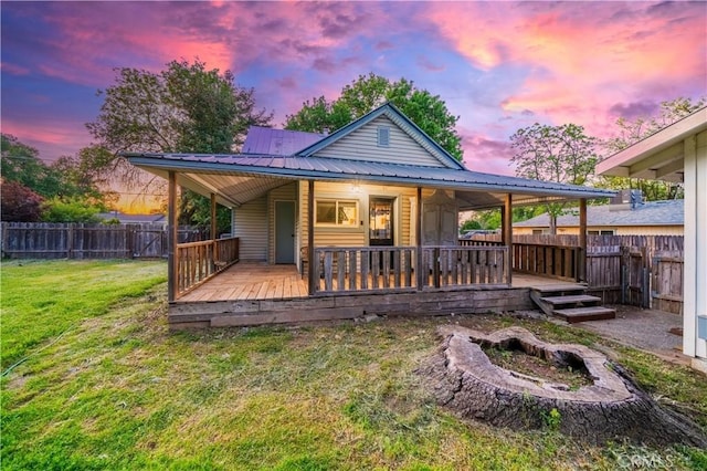 1711 Shasta St, Anderson, CA 96007 - back of property at dusk featuring a fenced backyard and a metal roof