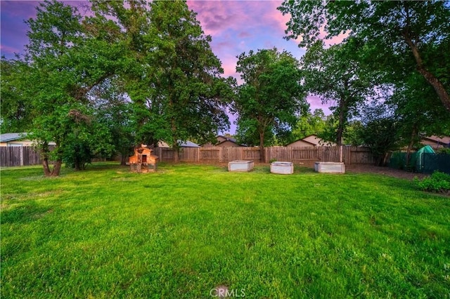 1711 Shasta St, Anderson, CA 96007 - yard at dusk with a fenced backyard and a playground