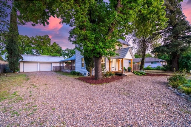 1711 Shasta St, Anderson, CA 96007 - view of front facade with a porch, an outbuilding, gravel driveway, and a metal roof