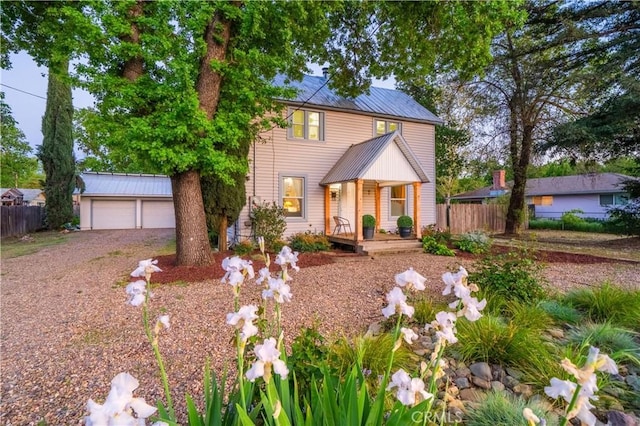 1711 Shasta St, Anderson, CA 96007 - traditional-style house featuring a detached garage, a porch, an outdoor structure, and a metal roof