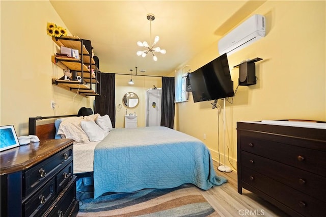 1711 Shasta St, Anderson, CA 96007 - bedroom with light wood-type flooring, a wall mounted air conditioner, and a chandelier