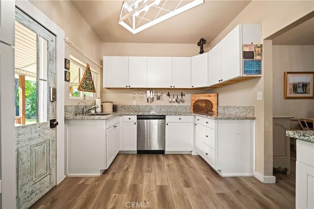 1711 Shasta St, Anderson, CA 96007 - kitchen featuring stainless steel dishwasher, light wood-type flooring, white cabinetry, and light stone countertops