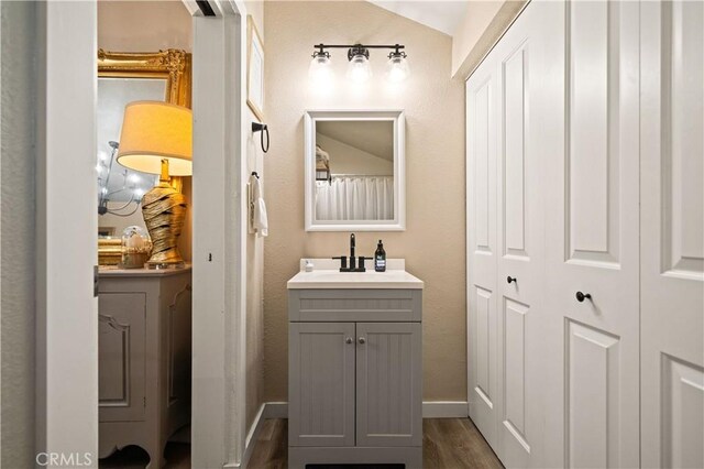 1711 Shasta St, Anderson, CA 96007 - full bath featuring vanity, wood finished floors, and a closet