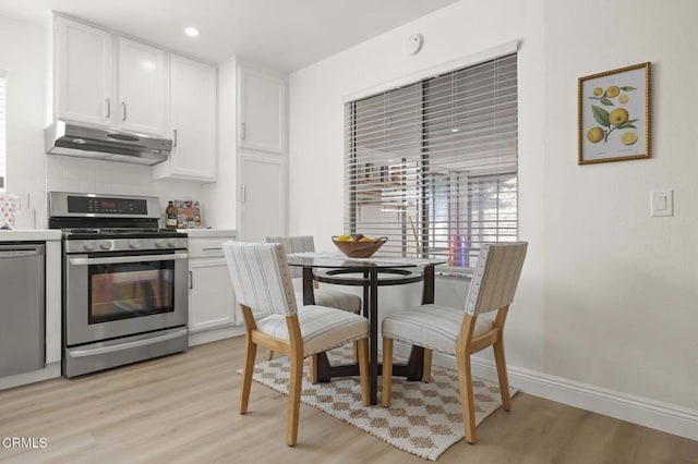 5217 Hillridge Dr, Camarillo, CA 93012 - kitchen with stainless steel appliances, under cabinet range hood, light wood finished floors, white cabinets, and recessed lighting