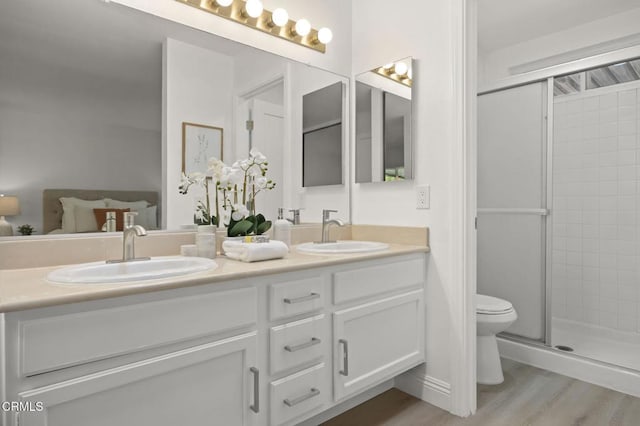 5217 Hillridge Dr, Camarillo, CA 93012 - bathroom with double vanity, a shower stall, and wood finished floors