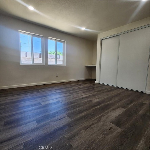 3087 N Lugo Ave, San Bernardino, CA 92404 - unfurnished bedroom featuring dark wood finished floors, a closet, and recessed lighting