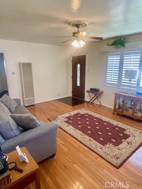 15343 Leahy Ave, Bellflower, CA 90706 - living area with a heating unit, wood finished floors, and a ceiling fan