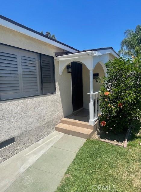 15343 Leahy Ave, Bellflower, CA 90706 - entrance to property with stucco siding and covered porch