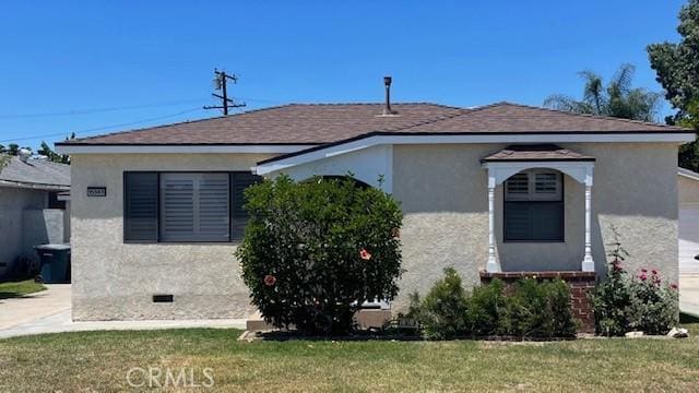 15343 Leahy Ave, Bellflower, CA 90706 - view of front of home with stucco siding, a front yard, and crawl space