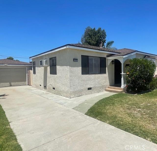 15343 Leahy Ave, Bellflower, CA 90706 - view of front of house with stucco siding, crawl space, a garage, driveway, and a front yard