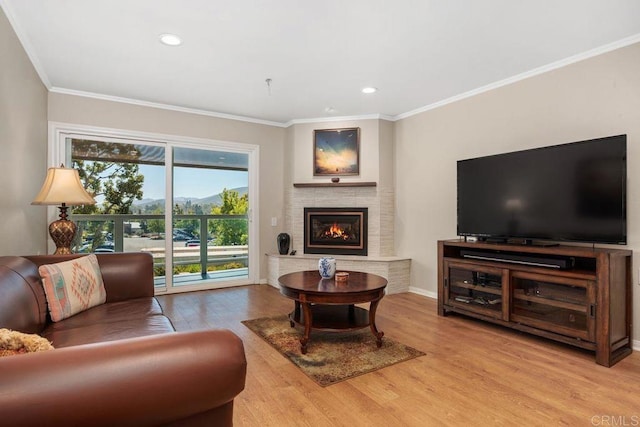 1560 Circa Del Lago Unit D204, San Marcos, CA 92078 - living area with light wood-style floors, ornamental molding, a brick fireplace, and recessed lighting