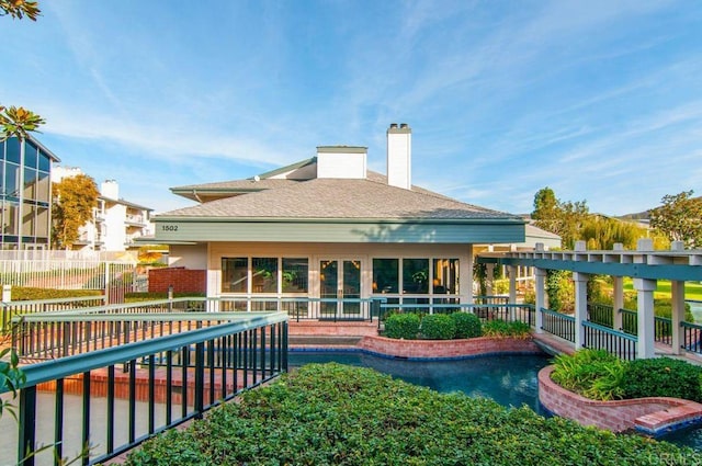 1560 Circa Del Lago Unit D204, San Marcos, CA 92078 - rear view of house featuring a chimney