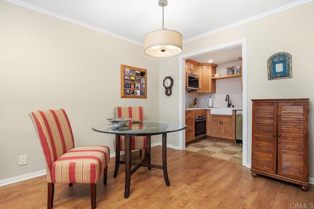 1560 Circa Del Lago Unit D204, San Marcos, CA 92078 - dining area featuring light wood-type flooring and crown molding
