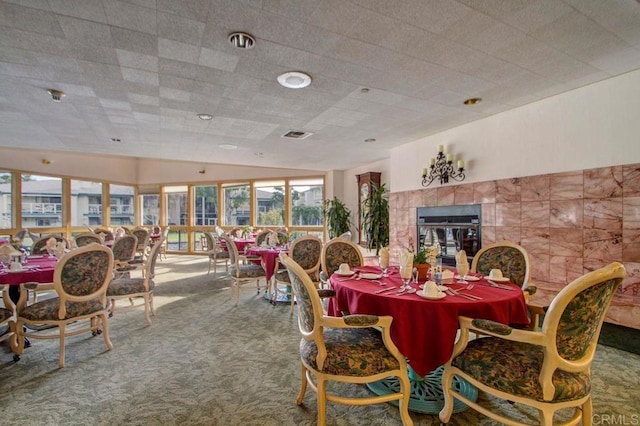1560 Circa Del Lago Unit D204, San Marcos, CA 92078 - dining room with carpet, a fireplace, and vaulted ceiling