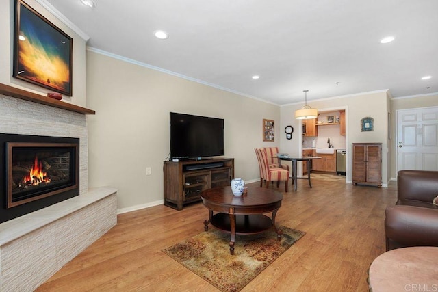 1560 Circa Del Lago Unit D204, San Marcos, CA 92078 - living area featuring crown molding, recessed lighting, light wood-type flooring, and a fireplace