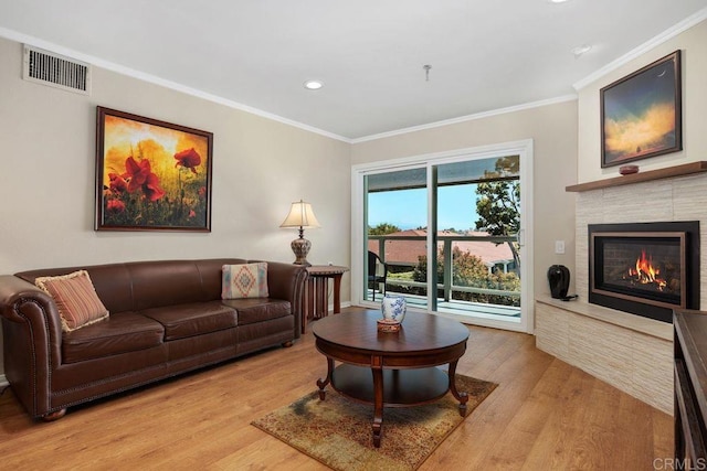 1560 Circa Del Lago Unit D204, San Marcos, CA 92078 - living room featuring ornamental molding, light wood-type flooring, recessed lighting, and a glass covered fireplace
