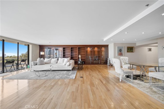 10660 Wilshire Blvd Unit 609, Los Angeles, CA 90024 - living room with wood finished floors, a wall of windows, and built in shelves