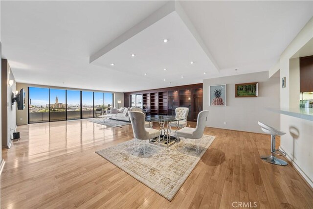 10660 Wilshire Blvd Unit 609, Los Angeles, CA 90024 - living area with a wall of windows, light wood finished floors, and recessed lighting