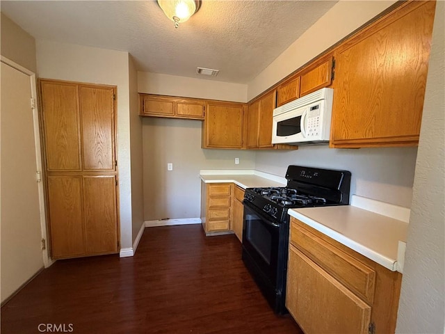 1767 Vasili Ln, Beaumont, CA 92223 - kitchen with black range with gas cooktop, white microwave, dark wood-type flooring, light countertops, and brown cabinetry