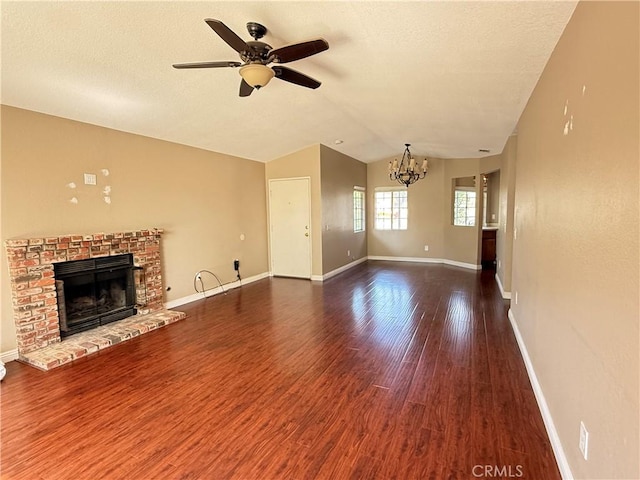 1767 Vasili Ln, Beaumont, CA 92223 - unfurnished living room featuring a chandelier, ceiling fan, a fireplace, wood finished floors, and lofted ceiling