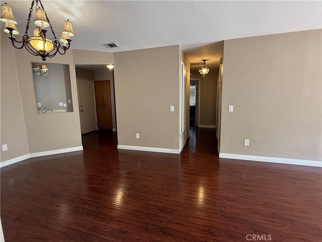 1767 Vasili Ln, Beaumont, CA 92223 - unfurnished room featuring a chandelier, wood finished floors, and a textured ceiling