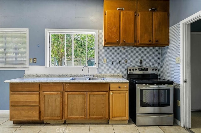 16374 35th Ave Unit 2, Clearlake, CA 95422 - kitchen with stainless steel range with electric cooktop, brown cabinetry, and light tile patterned floors