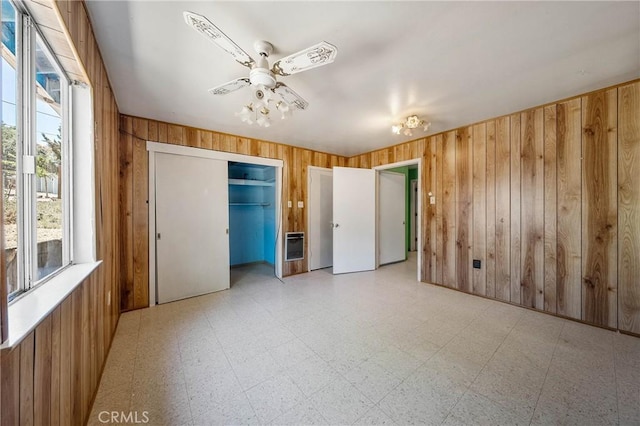 16374 35th Ave Unit 2, Clearlake, CA 95422 - unfurnished bedroom featuring wooden walls, light floors, heating unit, and a closet