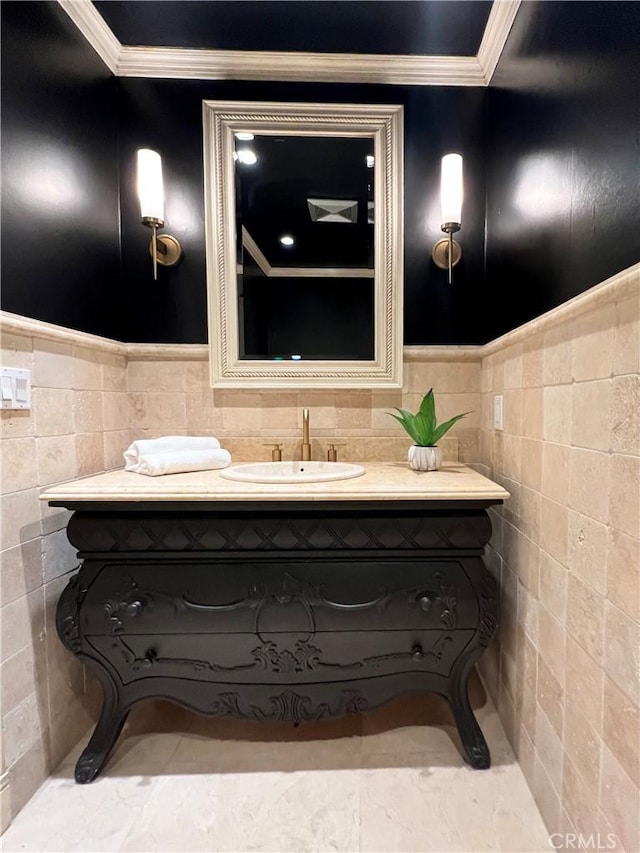 16815 Bajio Rd, Encino, CA 91436 - bathroom featuring ornamental molding, tile walls, vanity, and a wainscoted wall