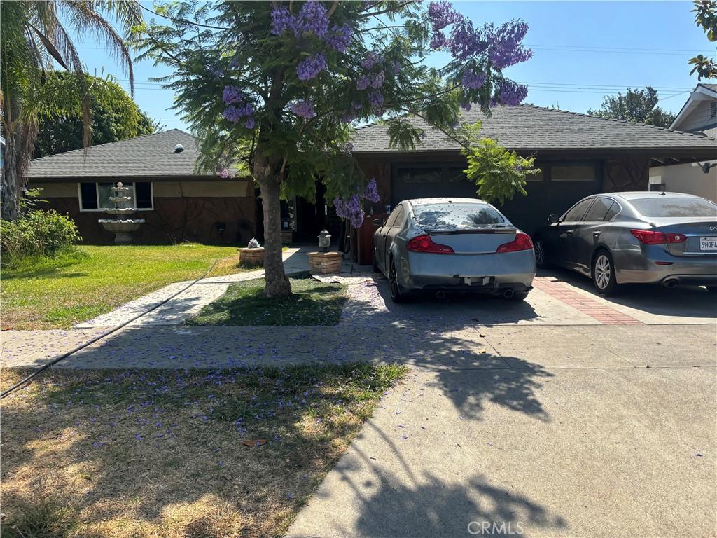 225 N Malena Dr, Orange, CA 92869 - ranch-style home with concrete driveway, an attached garage, and a shingled roof