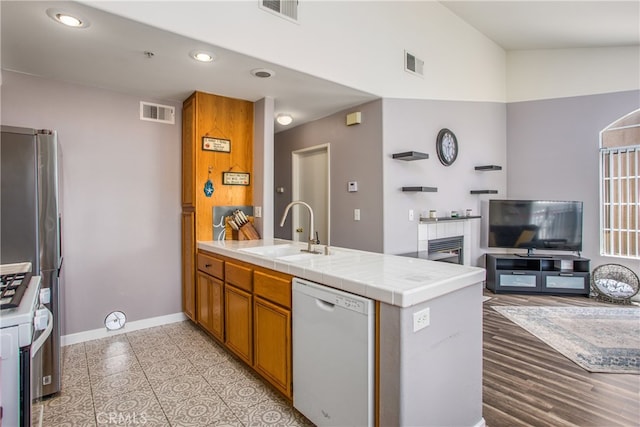 25545 Prospect Ave, Loma Linda, CA 92354 - kitchen with white dishwasher, a peninsula, gas range, open floor plan, and recessed lighting