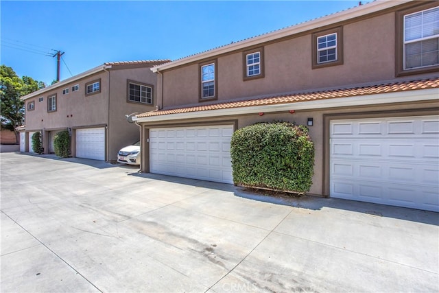 25545 Prospect Ave, Loma Linda, CA 92354 - mediterranean / spanish house featuring stucco siding, a garage, a tile roof, and concrete driveway