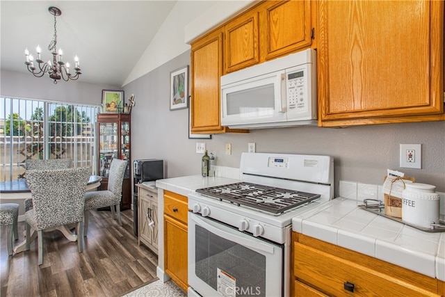 25545 Prospect Ave, Loma Linda, CA 92354 - kitchen featuring white appliances, a chandelier, lofted ceiling, tile countertops, and dark wood finished floors
